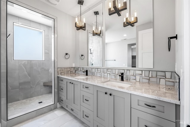 bathroom with decorative backsplash, vanity, and tiled shower