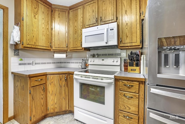 3242 S 2000 E, Wendell, ID 83355 - kitchen featuring backsplash, white appliances, light countertops, and brown cabinets