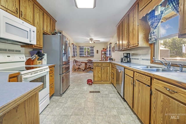3242 S 2000 E, Wendell, ID 83355 - kitchen featuring light countertops, brown cabinetry, appliances with stainless steel finishes, and a sink
