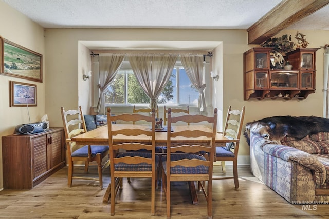 3242 S 2000 E, Wendell, ID 83355 - dining space featuring light wood finished floors, beamed ceiling, and a textured ceiling