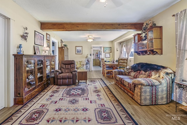 3242 S 2000 E, Wendell, ID 83355 - living area with wood finished floors, beam ceiling, a textured ceiling, and ceiling fan