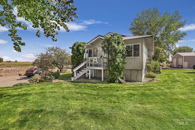 3242 S 2000 E, Wendell, ID 83355 - rear view of property featuring metal roof, stairs, and a yard