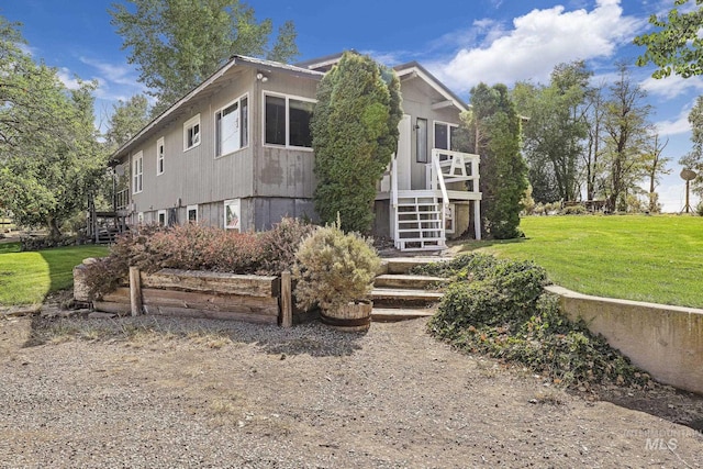 3242 S 2000 E, Wendell, ID 83355 - view of home's exterior featuring a wooden deck, a lawn, and stairs