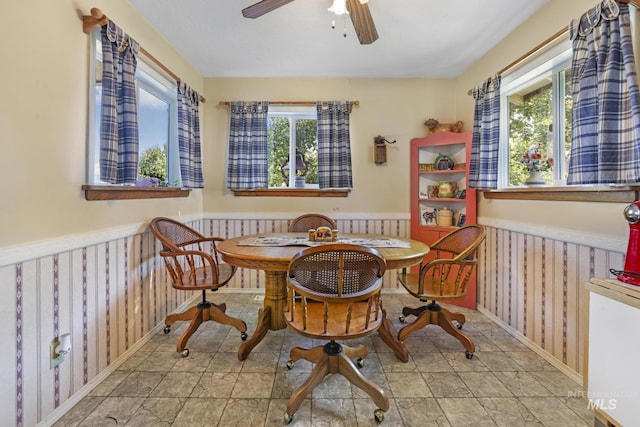 3242 S 2000 E, Wendell, ID 83355 - dining space featuring a wainscoted wall, wood walls, and ceiling fan