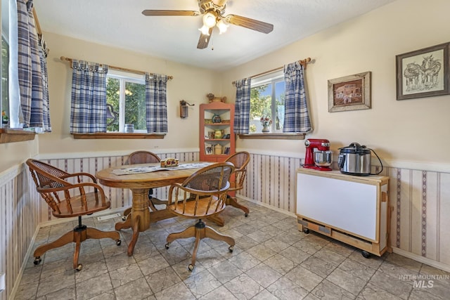 3242 S 2000 E, Wendell, ID 83355 - dining area featuring a wainscoted wall, wooden walls, and a ceiling fan