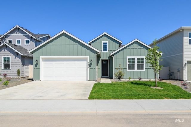 8900 W Snow Wolf Dr, Star, ID 83669 - view of front of home with board and batten siding, an attached garage, a front lawn, and concrete driveway