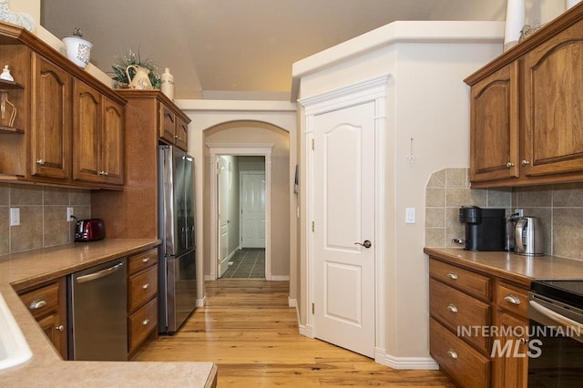 15697 Cupid Dr, Caldwell, ID 83607 - kitchen with light hardwood / wood-style flooring, appliances with stainless steel finishes, and tasteful backsplash