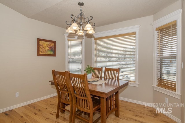 15697 Cupid Dr, Caldwell, ID 83607 - dining space featuring light hardwood / wood-style flooring and an inviting chandelier