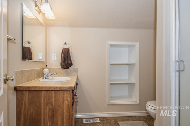 15697 Cupid Dr, Caldwell, ID 83607 - bathroom with vanity, built in shelves, toilet, a textured ceiling, and walk in shower