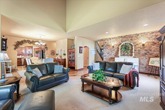 1404 Sandal Crk, Nampa, ID 83686 - living area featuring a chandelier, arched walkways, brick wall, and light colored carpet
