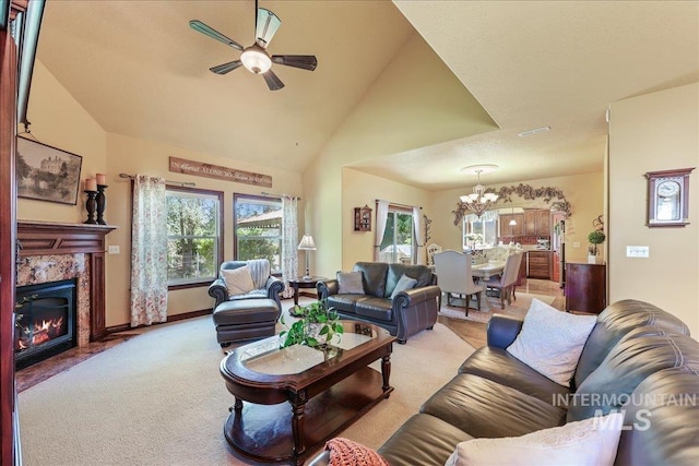 1404 Sandal Crk, Nampa, ID 83686 - living room with a chandelier, ceiling fan, a tile fireplace, light colored carpet, and vaulted ceiling