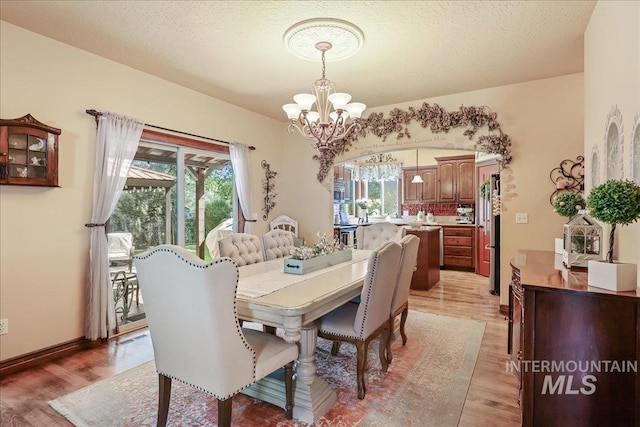1404 Sandal Crk, Nampa, ID 83686 - dining space with a chandelier and light wood-style flooring