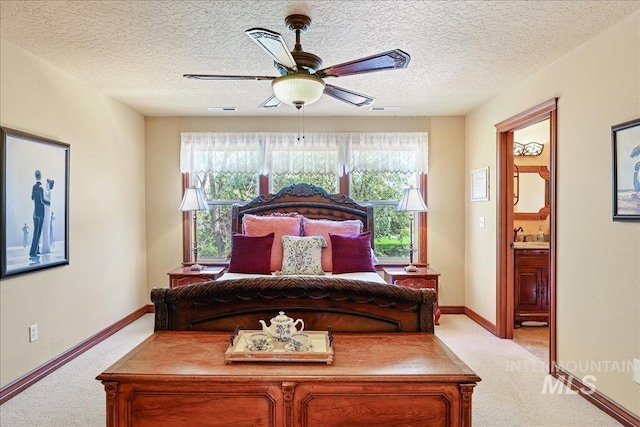 1404 Sandal Crk, Nampa, ID 83686 - bedroom featuring light colored carpet, baseboards, ensuite bathroom, a ceiling fan, and a textured ceiling