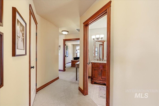1404 Sandal Crk, Nampa, ID 83686 - corridor featuring light carpet, a sink, and baseboards