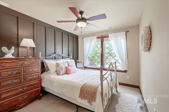 1404 Sandal Crk, Nampa, ID 83686 - bedroom featuring light carpet, a textured ceiling, baseboards, and ceiling fan