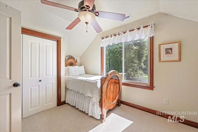 1404 Sandal Crk, Nampa, ID 83686 - bedroom with vaulted ceiling, light carpet, ceiling fan, baseboards, and a closet
