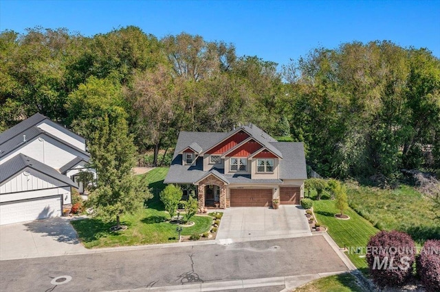 1404 Sandal Crk, Nampa, ID 83686 - view of front of house with concrete driveway, stone siding, an attached garage, and a front lawn