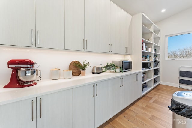 kitchen featuring white cabinets and light wood-type flooring