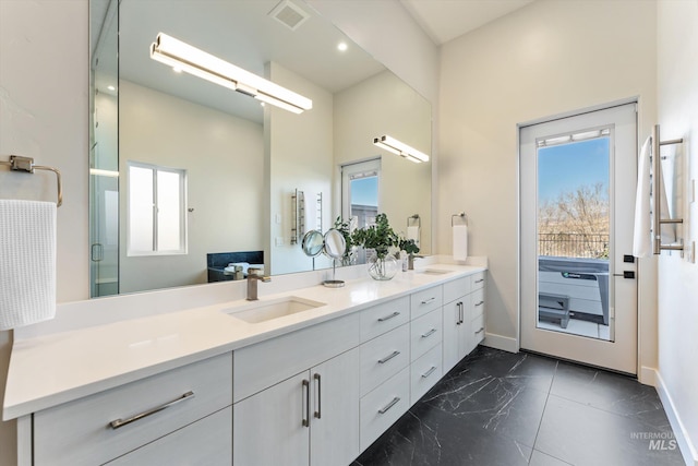 bathroom with walk in shower and vanity