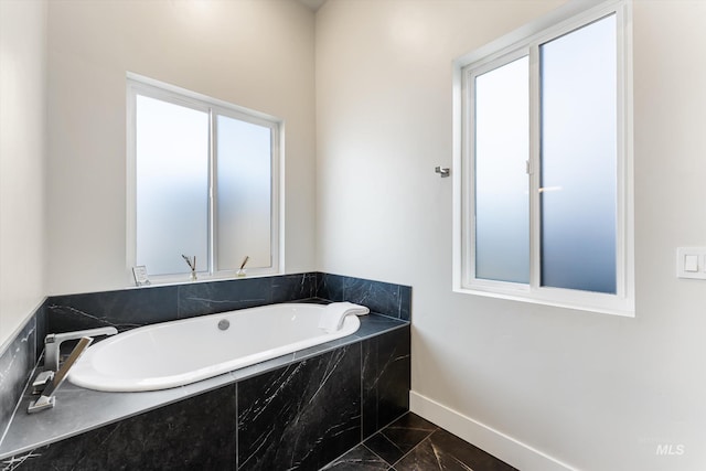 bathroom featuring tiled tub