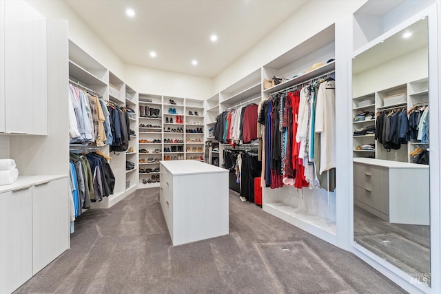 walk in closet featuring dark carpet