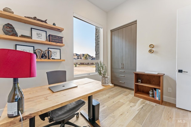 office space with plenty of natural light and light wood-type flooring