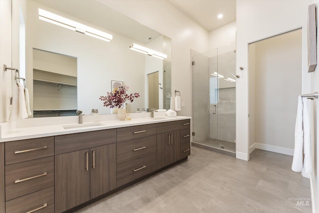 bathroom featuring an enclosed shower and vanity