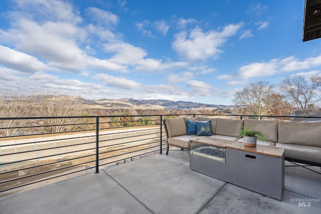 view of patio with an outdoor living space and a mountain view