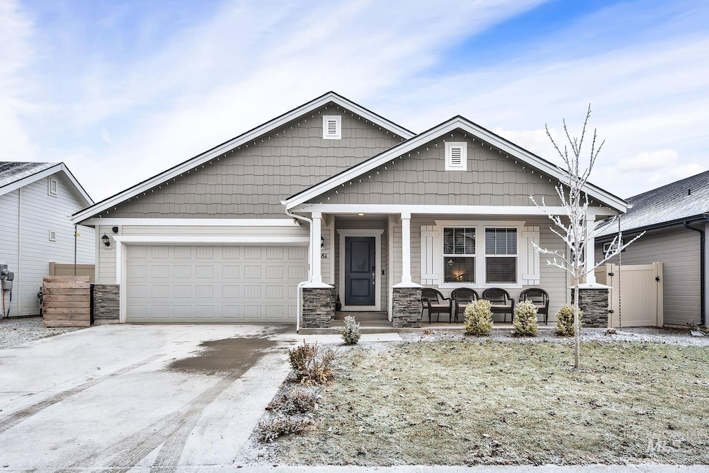 craftsman-style home with covered porch and a garage