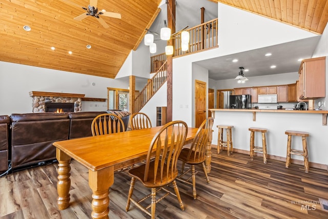 10389 Gamann Dr, Cascade, ID 83611 - dining area with high vaulted ceiling, wood ceiling, ceiling fan, wood finished floors, and stairs