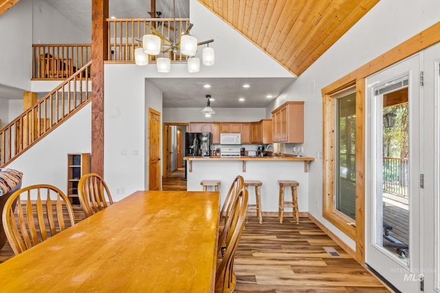 10389 Gamann Dr, Cascade, ID 83611 - dining room with light wood-type flooring, a chandelier, high vaulted ceiling, wood ceiling, and stairs