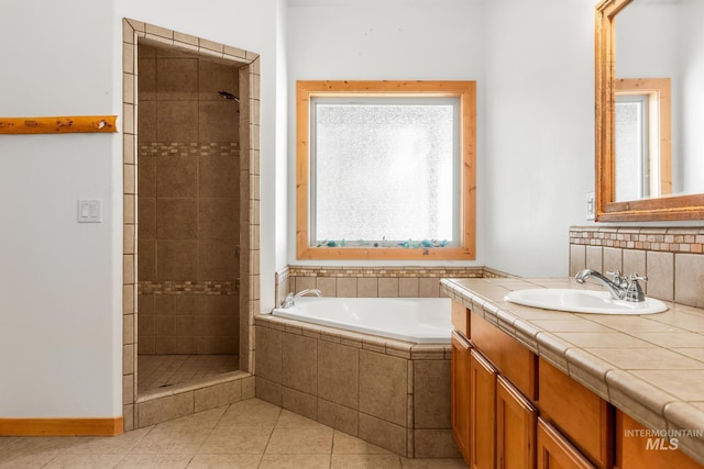 10389 Gamann Dr, Cascade, ID 83611 - full bathroom featuring a stall shower, vanity, a bath, and tile patterned floors