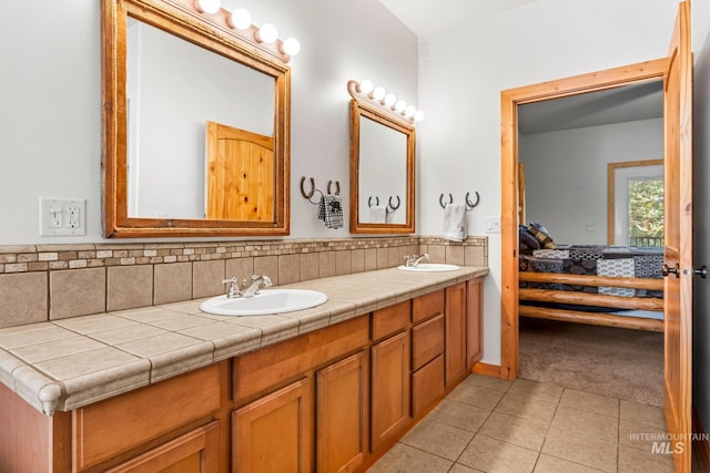 10389 Gamann Dr, Cascade, ID 83611 - bathroom featuring ensuite bathroom, double vanity, and tile patterned floors