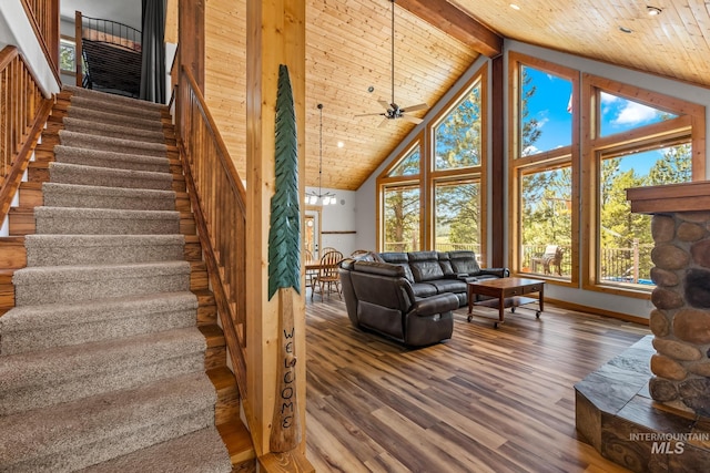 10389 Gamann Dr, Cascade, ID 83611 - living room featuring wood finished floors, a wooden ceiling with exposed beams, high vaulted ceiling, stairway, and ceiling fan