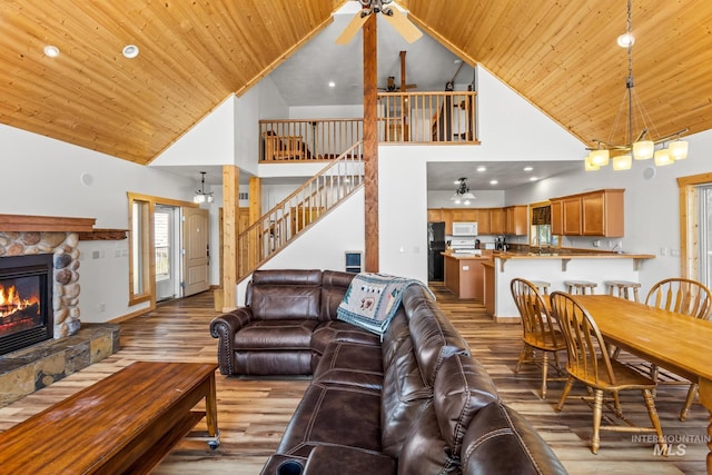 10389 Gamann Dr, Cascade, ID 83611 - living room with ceiling fan, high vaulted ceiling, wood finished floors, a stone fireplace, and wooden ceiling
