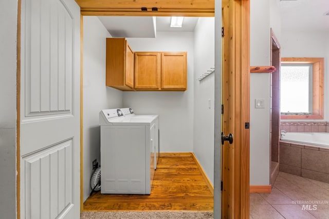 10389 Gamann Dr, Cascade, ID 83611 - laundry room with cabinet space, washer and dryer, and tile patterned flooring