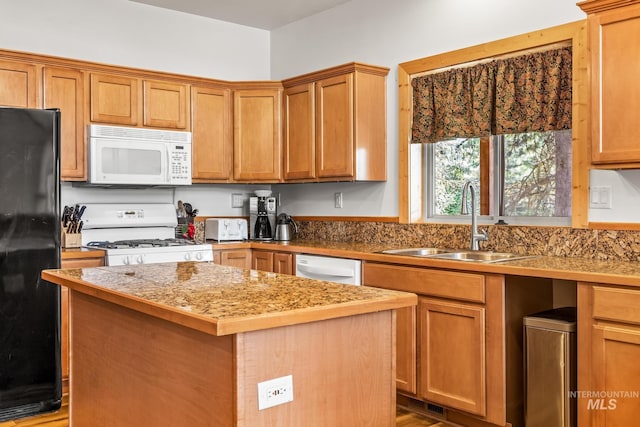 10389 Gamann Dr, Cascade, ID 83611 - kitchen featuring white appliances, a kitchen island, and brown cabinets