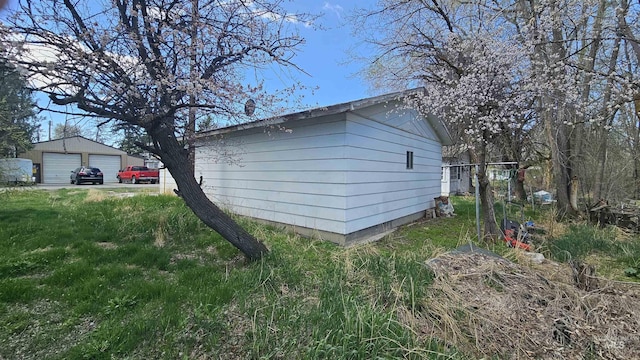 view of home's exterior featuring a garage and an outbuilding