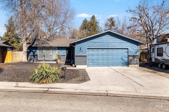 single story home featuring concrete driveway, brick siding, an attached garage, and fence