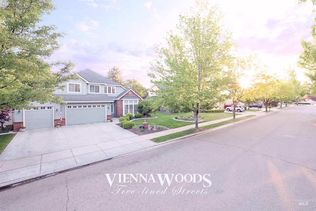 view of front of house featuring driveway, a front lawn, brick siding, and a garage