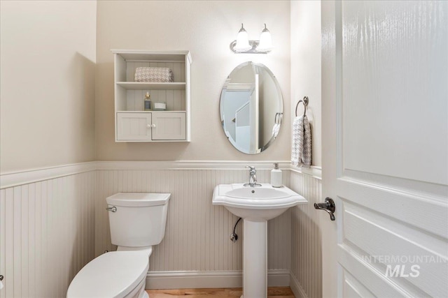 bathroom with toilet and wainscoting