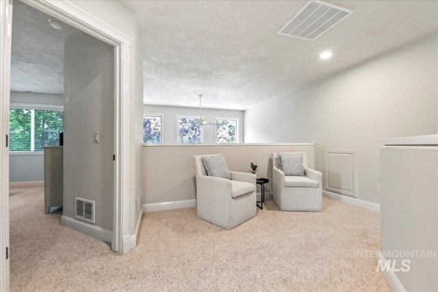 sitting room with carpet, baseboards, plenty of natural light, and recessed lighting
