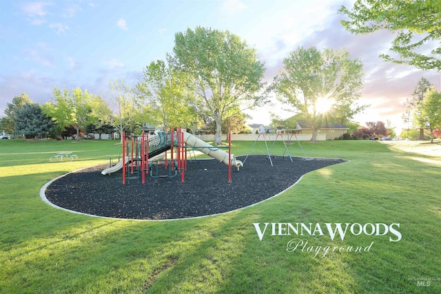 community jungle gym featuring a yard