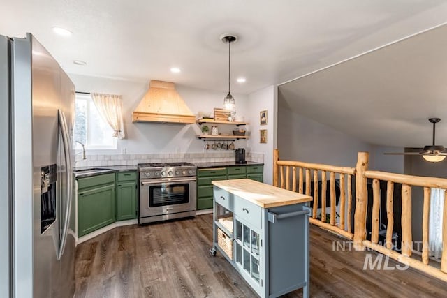 kitchen featuring green cabinetry, open shelves, custom range hood, appliances with stainless steel finishes, and butcher block counters