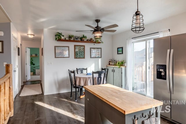 kitchen with ceiling fan, baseboards, dark wood finished floors, stainless steel refrigerator with ice dispenser, and wood counters