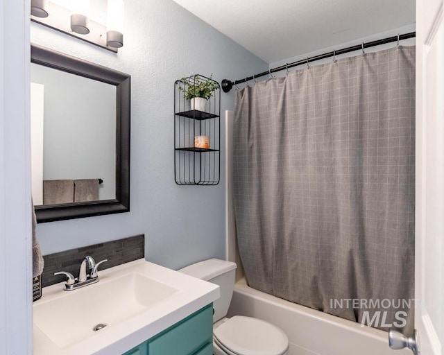 full bath with vanity, shower / tub combo, and toilet