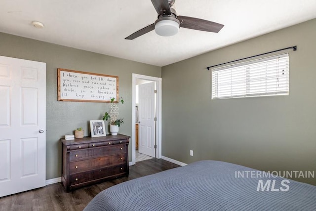 bedroom featuring ceiling fan, baseboards, and dark wood-style flooring