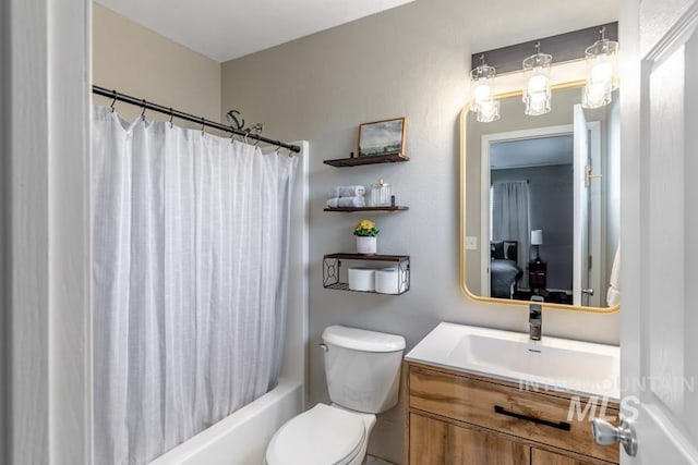 bathroom with toilet, vanity, and shower / bath combination with curtain