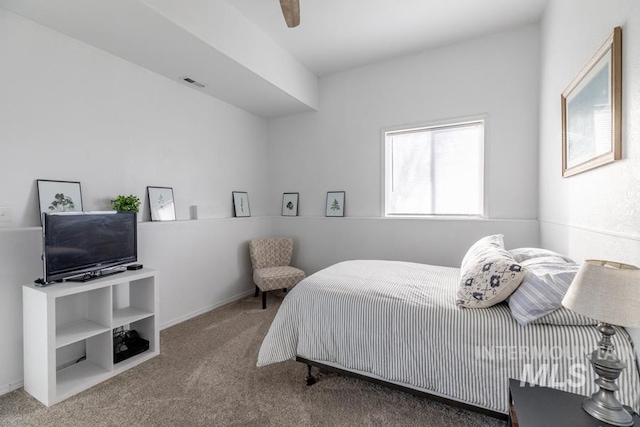 carpeted bedroom with visible vents and ceiling fan