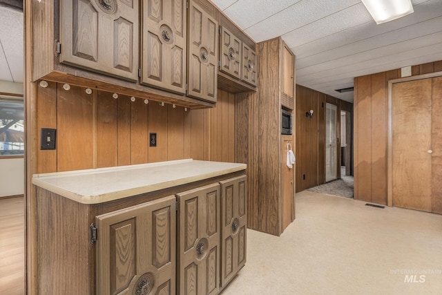 interior space featuring wooden walls and built in microwave